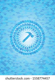 hammer icon inside sky blue emblem with mosaic background