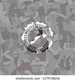 hammer icon on grey camo texture
