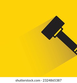hammer with shadow on yellow background