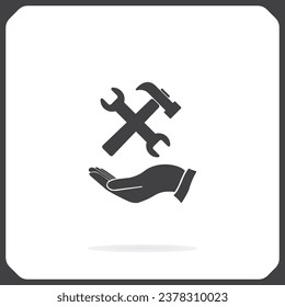 martillo y llave en la mano, icono vector