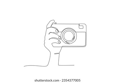 A hand adjusts the camera angle. World photography day one-line drawing