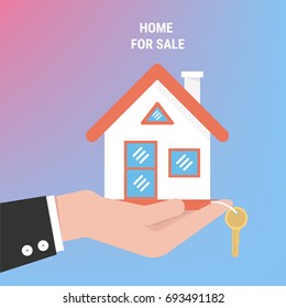  Agente de mano con el hogar en la palma y la llave en el dedo. Oferta de la casa de compra