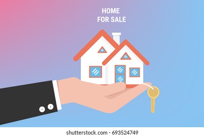 Hand agent with home in palm and key on finger. Offer of purchase house