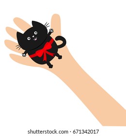 Hand arm holding black cat with red bow ribbon. Adopt animal pet. Helping hands concept. Funny gift. Cute cartoon character. Close up body part. Flat design style. White background. Isolated. Vector