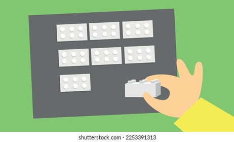 The hand arranges the constructor's cubes on the base