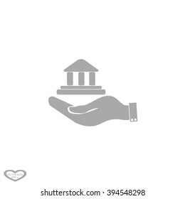 Hand and bank building. Vector. Bank building icon.