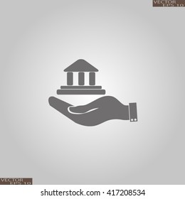 Hand and bank building. Vector. Bank building icon.