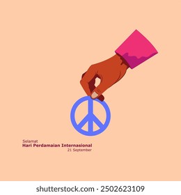 Hand with blue peace symbol and Indonesian text Happy International Peace Day. September 21.