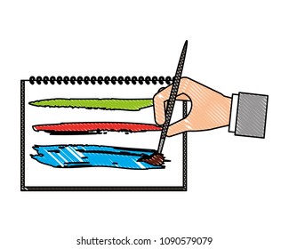 hand with brush painting picture in book