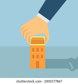 a hand of business man put a building or a house vector illustration