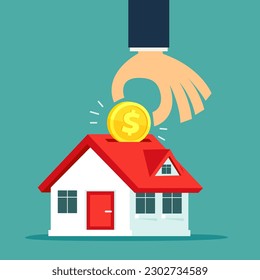 Hand of businessman put gold coin with dollar sign  into house shape piggy bank. Real estate investment business concept.