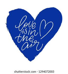 Hand calligraphy lettering text with blue heart: Love is in the air, isolated vector quote.