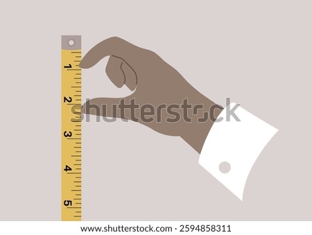 A hand carefully grips a measuring tape, showcasing the importance of accuracy in measurements during a project in a creative environment