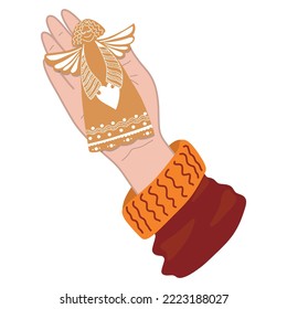 a hand with a Christmas gingerbread in the form of an angel.