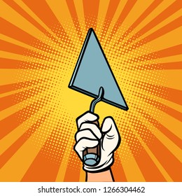 hand with construction trowel. Comic cartoon pop art retro vector illustration drawing