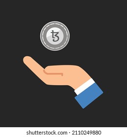 Estilo plano del icono vectorial de la mano y el cripto tezos de la moneda aislado.