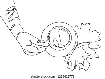 Hand with cup of coffee or tea with leaves. Continuous line
