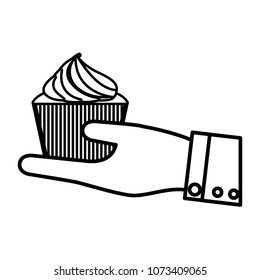 hand with delicious and sweet cupcake