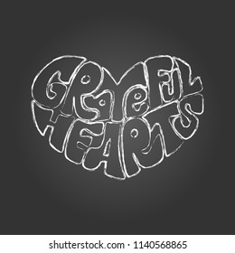 Hand draw chalk lettering: "Grateful hearts"  in the form of the heart on black background.