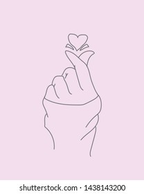 A hand drawing forms a symbol of love in the Korean tradition
