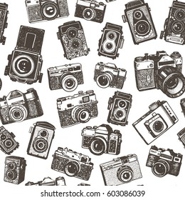 Hand drawing retro photo cameras seamless pattern background.