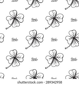 Hand drawing symbols of luck seamless pattern. Vector background with slogan and quatrefoil on white background. Chess grid order