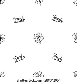 Hand drawing symbols of luck seamless pattern. Vector background with slogan and clover on white background. Chess grid order