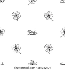 Hand drawing symbols of luck seamless pattern. Vector background with slogan, clover, quatrefoil on white background. Chess grid order