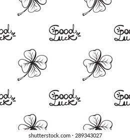 Hand drawing symbols of luck seamless pattern. Vector background with slogan and quatrefoil on white background. Chess grid order