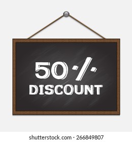 Hand drawn 50% discount on chalkboard hanging on the wall.