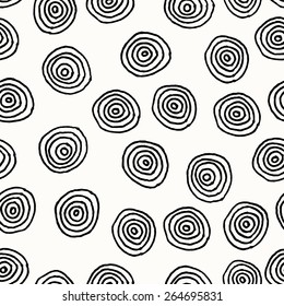 Hand drawn abstract seamless repeat pattern with round shapes in black and white.