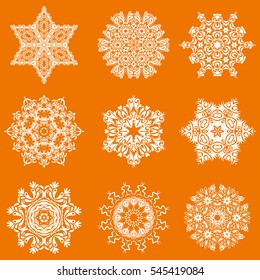 Hand drawn abstract snowflakes set. Template for cover, poster, t-shirt or fabric. Vector winter illustration on a orange background.