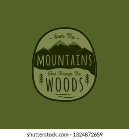 Hand drawn adventure logo with mountain, pine trees forest and quote - Over the Mountains and through the woods. Old style camp outdoors emblem in retro style. Stock vector illustration.