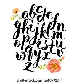 Hand drawn alphabet written with brush pen. Letters are decorated with watercolor flowers.