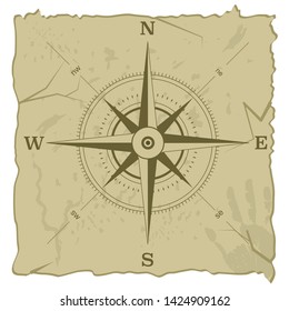 Hand drawn antique compass. Old paper texture background with stain marks.