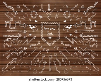 Hand drawn arrow icons set on wooden texture. Vector Illustration