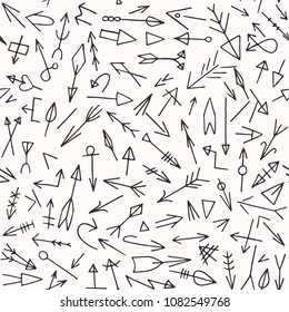 Hand drawn arrow vector pattern. Tribal doodle arrows seamless background.
