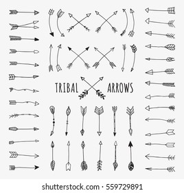 Hand drawn arrows set. Doodle tribal vectors isolated on off-white background.