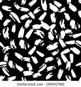 Hand drawn artistic brush seamless pattern. Animals skin wallpaper.  Abstract white ink repeating on black background.  Vector illustration.