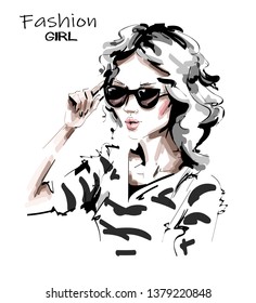 Hand drawn beautiful young woman in sunglasses. Lady in striped shirt. Stylish girl. Fashion woman look. Sketch. Vector illustration.