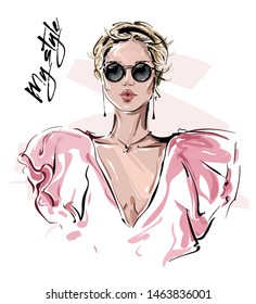 Hand drawn beautiful young woman in sunglasses. Stylish girl. Fashion woman look. Sketch. Vector illustration.