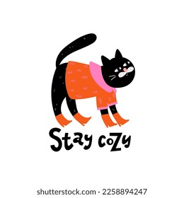 Hand drawn black cat is standing in a bright shirt and boots and text - stay cozy isolated on white background. Perfect for print on t shirt or card 
