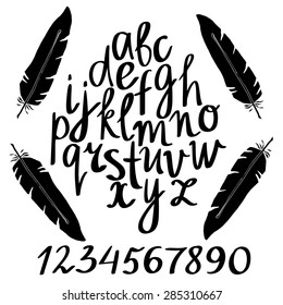 Hand drawn black sketch calligraphical alphabet, font, letters, numbers and feathers isolated on black background 