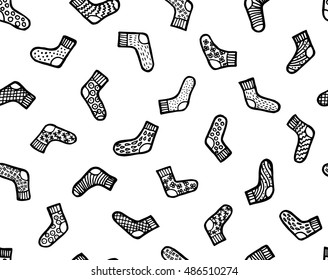 Hand drawn black and white seamless vector pattern. Warm doddle socks for winter.