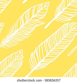 Hand drawn boho illustration. Yellow seamless pattern with feathers. Vector creative art-work. Ink drawing in bohemian chic style