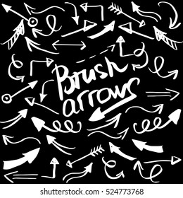 Hand drawn brush arrow. Sketch design concept. Set arrows isolated on the black background. 