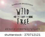 Hand drawn brush font on a blurred vintage style mountain view background. EPS 10 file, gradient mesh and transparency effects used.