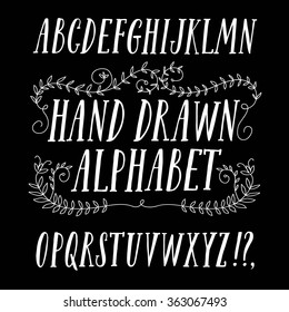 Hand drawn brush ink vector ABC letters set with floral ornament. Trendy doodle calligraphy font for your design.