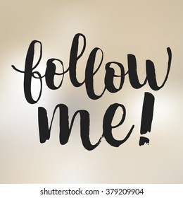 Hand drawn brush lettering "follow me!" on light blurred background