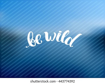 Hand drawn calligraphy. concept handwritten poster. "be wild" creative graphic template brush fonts inspirational quotes. motivational illustration on blue of the sea blurred landscape